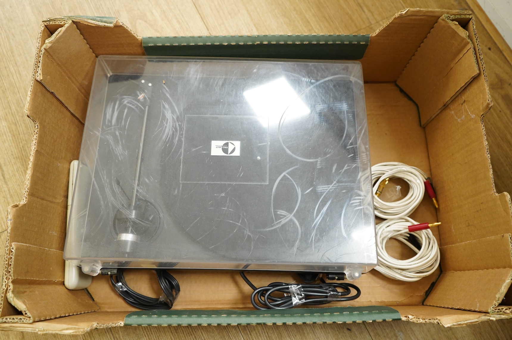 A collection of stereo equipment, including a Project P1 turntable record player, a Denon UPA-F10 integrated stereo amplifier with remote control, a boxed Kenwood KX-260 cassette tape player and a pair of Monitor Audio s